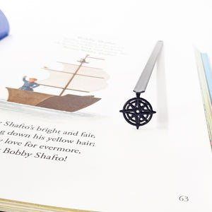 Compass rose bookmark in illustrated hardcover book, Bobby Shafto poem page with sailing ship