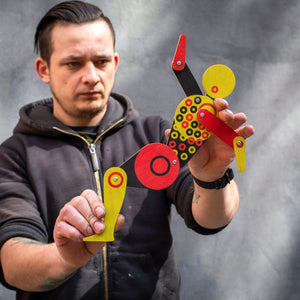 Maker posing Bauhaus circle dancer puppet with both hands showing movable jointed limbs