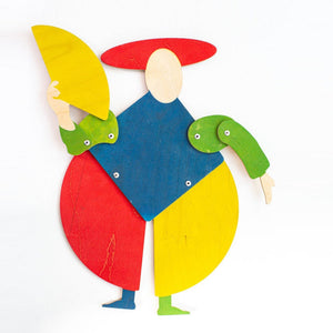 Colorful geometric harlequin puppet with red oval hat, blue diamond torso, red and yellow circular hips, green arms, natural wood face and feet