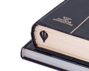 Hot Air Balloon metal bookmark in a closed book, only its top showing above the pages