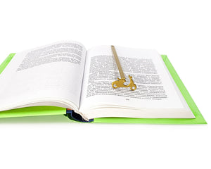 Motor Scooter metal bookmark in gold marking a page in an open book
