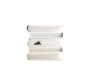 Mountain Climber metal bookmark shown with a stack of books