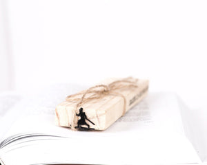 Skier in High Hat metal bookmark packed with kraft paper and twine as a gift
