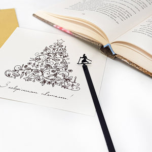 Skier in High Hat metal bookmark on an illustrated page