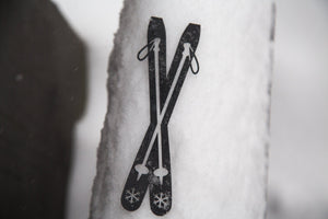 Skis metal bookmark against a coloured backdrop