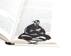 Ukrainian Kozak metal bookmark resting on the pages of an open book