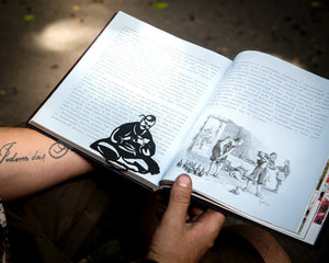 Ukrainian Kozak metal bookmark held in a hand above an open book