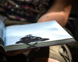 Ukrainian Kozak metal bookmark held in a hand to show its size