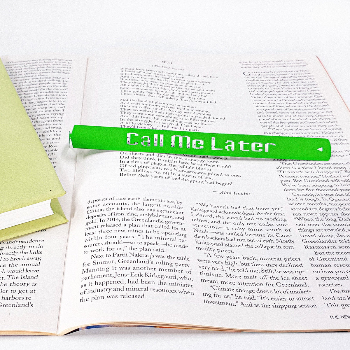 Call Me Later metal bookmark in green resting on the pages of an open book