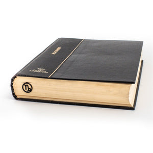 Capricorn metal bookmark in a closed book, only its top showing above the pages