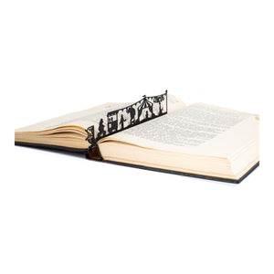 Circus metal bookmark resting on the pages of an open book