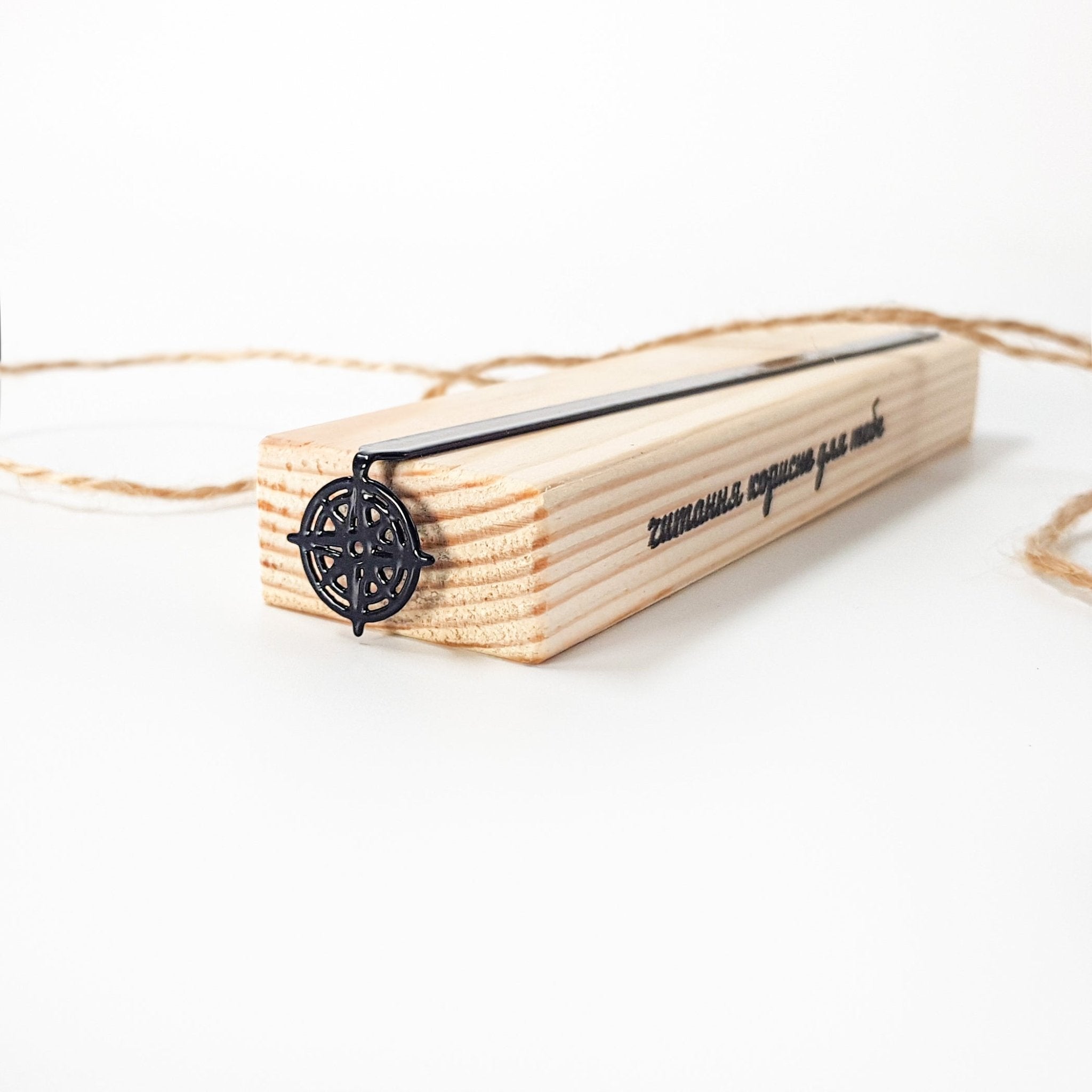 Compass rose bookmark on wooden block, reverse side with script lettering