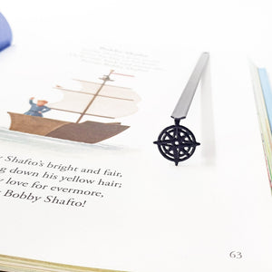 Compass rose bookmark in illustrated hardcover book, Bobby Shafto poem page with sailing ship