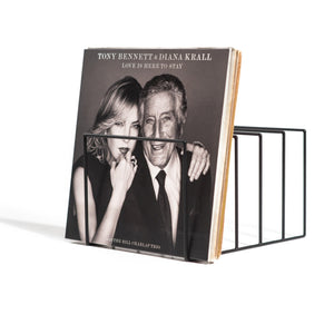 Minimalist black metal vinyl record holder displaying the album “Love Is Here to Stay” by Tony Bennett and Diana Krall, set against a white background.