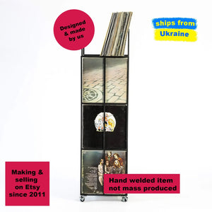 Side view of a black Four - tier Vinyl Record Stand on Rubber Wheels with records.