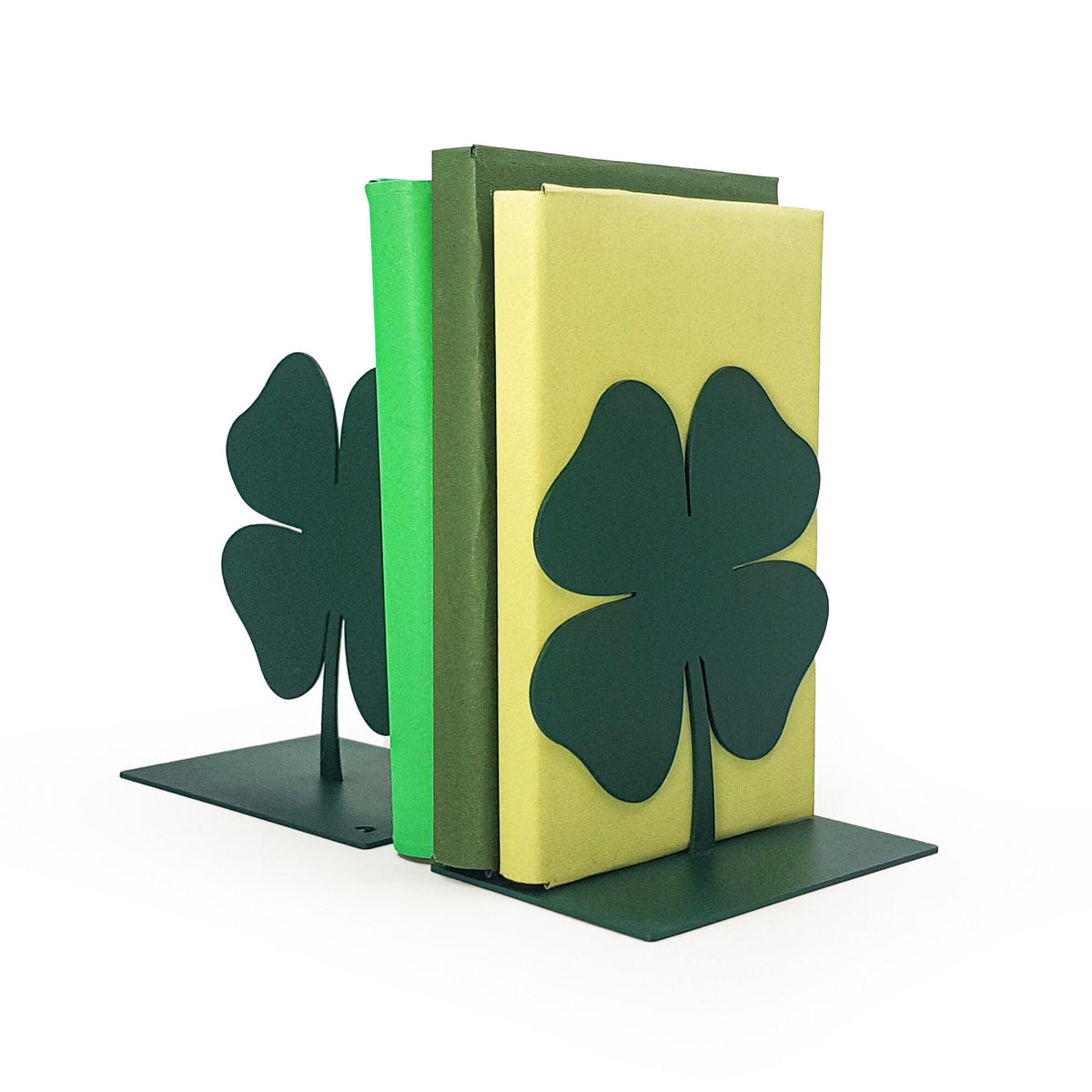 Minimalist four-leaf clover metal bookends in dark green, securely holding green and yellow books, modern and lucky design.