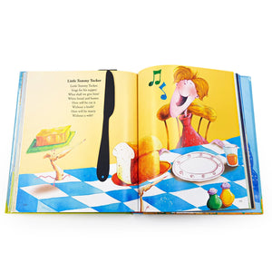 Black knife-shaped COOK bookmark placed vertically in the center of an open children’s book with colorful illustrations of bread, butter, and a smiling character.