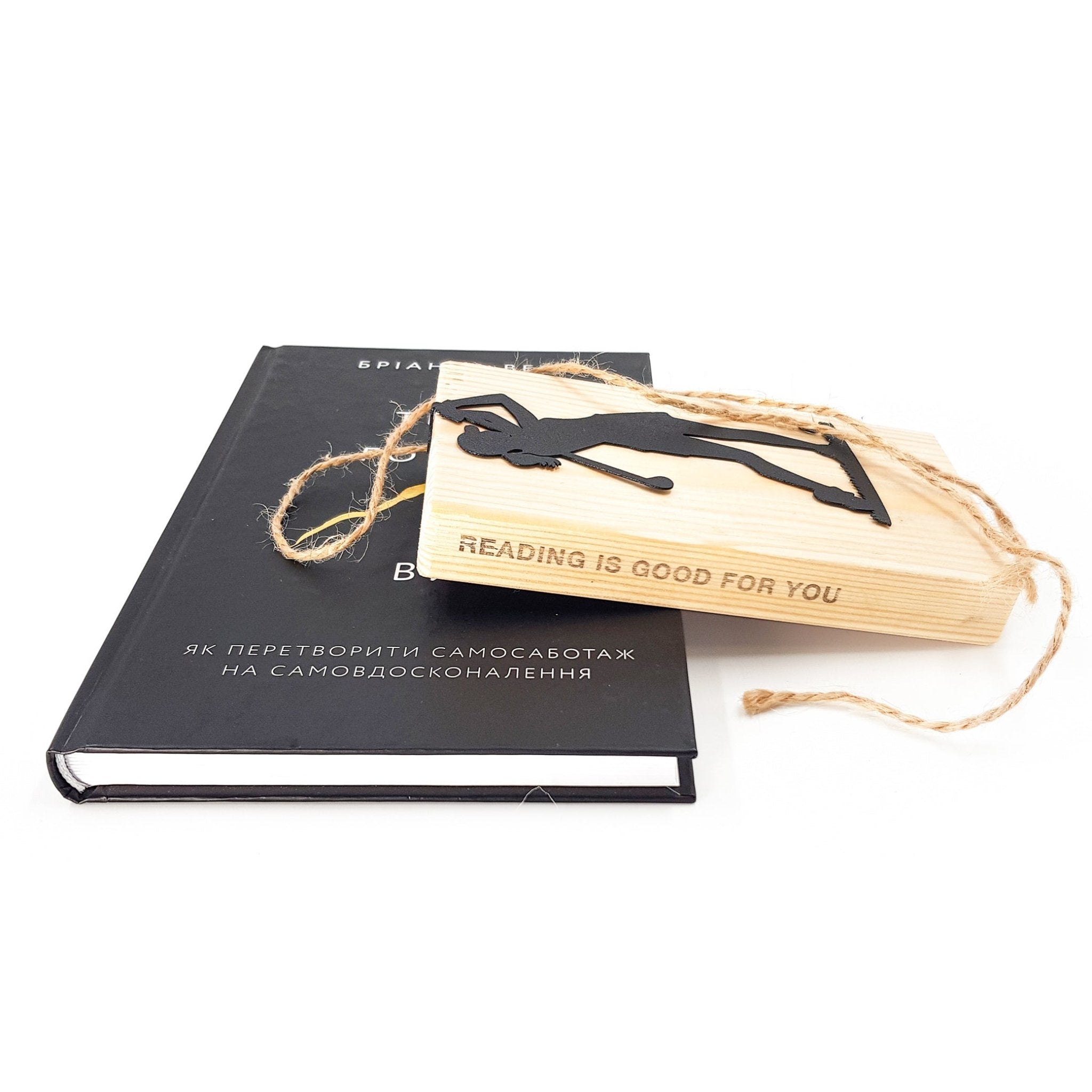 Black metal lady golf player bookmark displayed with a wooden engraved bookmark holder and a hardcover book, showing gift-ready presentation