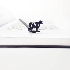 Metal cow bookmark detail shot showing cut-out spots on cow silhouette, matte black finish