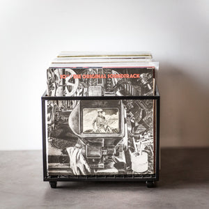 Compact black metal vinyl record holder on wheels, filled with LPs including the album “10cc – The Original Soundtrack,” photographed on a grey surface against a white background. Designed and made by Atelier Article in Ukraine.