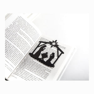 Nativity Scene metal bookmark resting on the pages of an open book