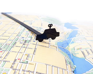 Wind-Up Toy Car metal bookmark on a coloured background