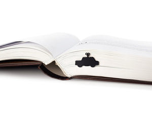 Wind-Up Toy Car metal bookmark marking a page in an open book