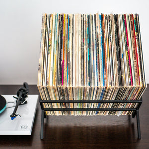 Black 1Romb metal vinyl record stand beside a turntable