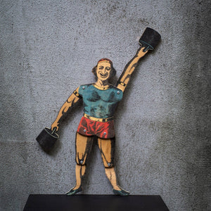 articulated plywood strongman puppet holding weights, vintage style with movable joints