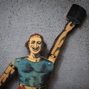 close up of plywood strongman puppet raising weight, vintage style articulated figure