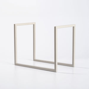 Minimalist metal vinyl record stand in beige displayed on white background.