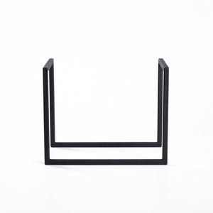 Side view of a minimalist metal vinyl record stand displayed on white background.