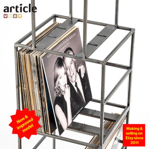 Close-up of upgraded vinyl record storage unit made of raw steel, showcasing Tony Bennett & Diana Krall LP, labeled as “New & improved model,” handcrafted and sold on Etsy since 2011.