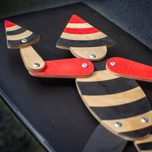 close up of handmade articulated plywood acrobat puppet showing joints and layered wood construction