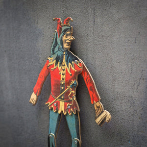 close up of handmade articulated plywood jester puppet showing printed details and joints