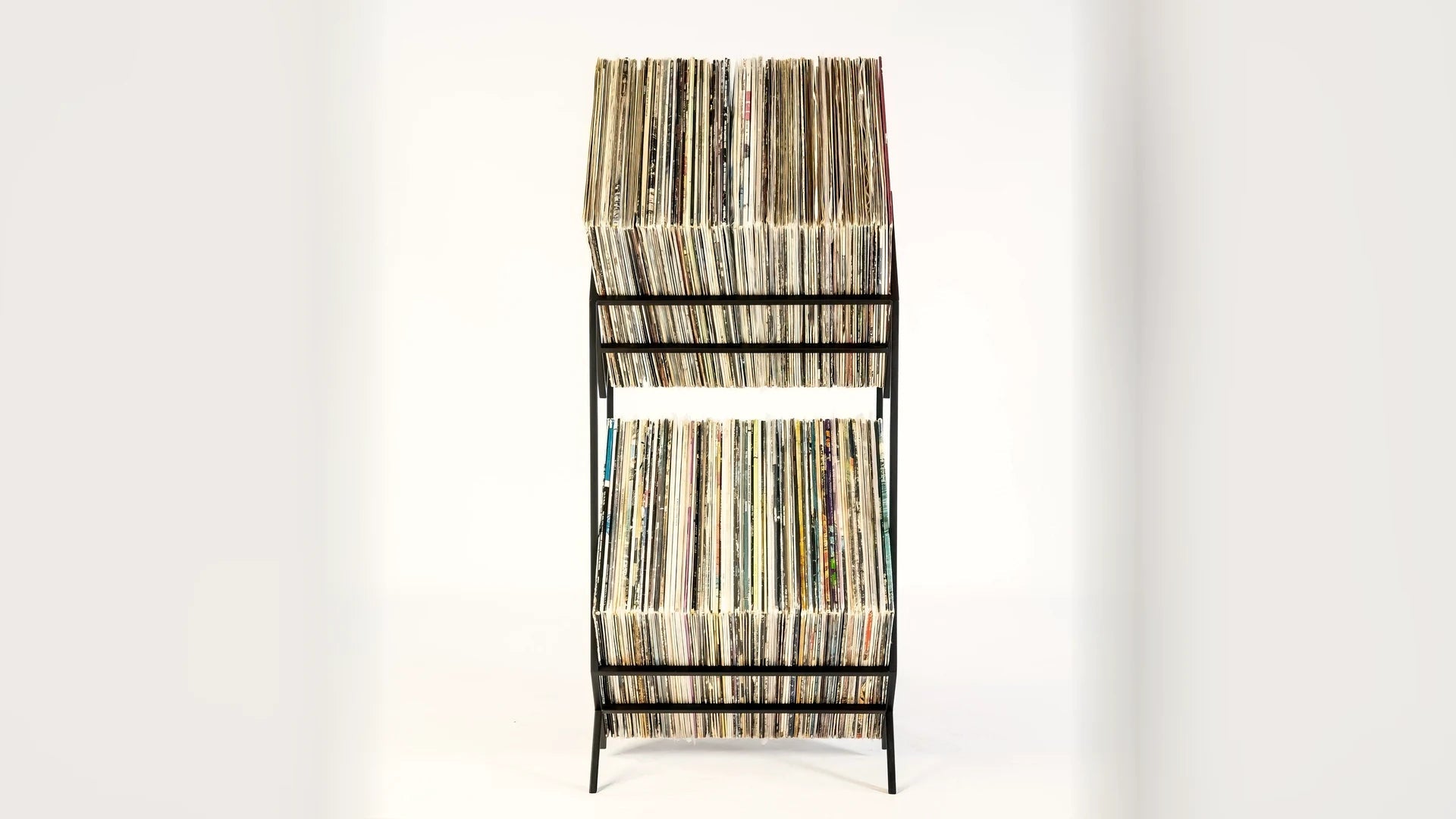 Tall two-tier steel rack filled with LP records.
