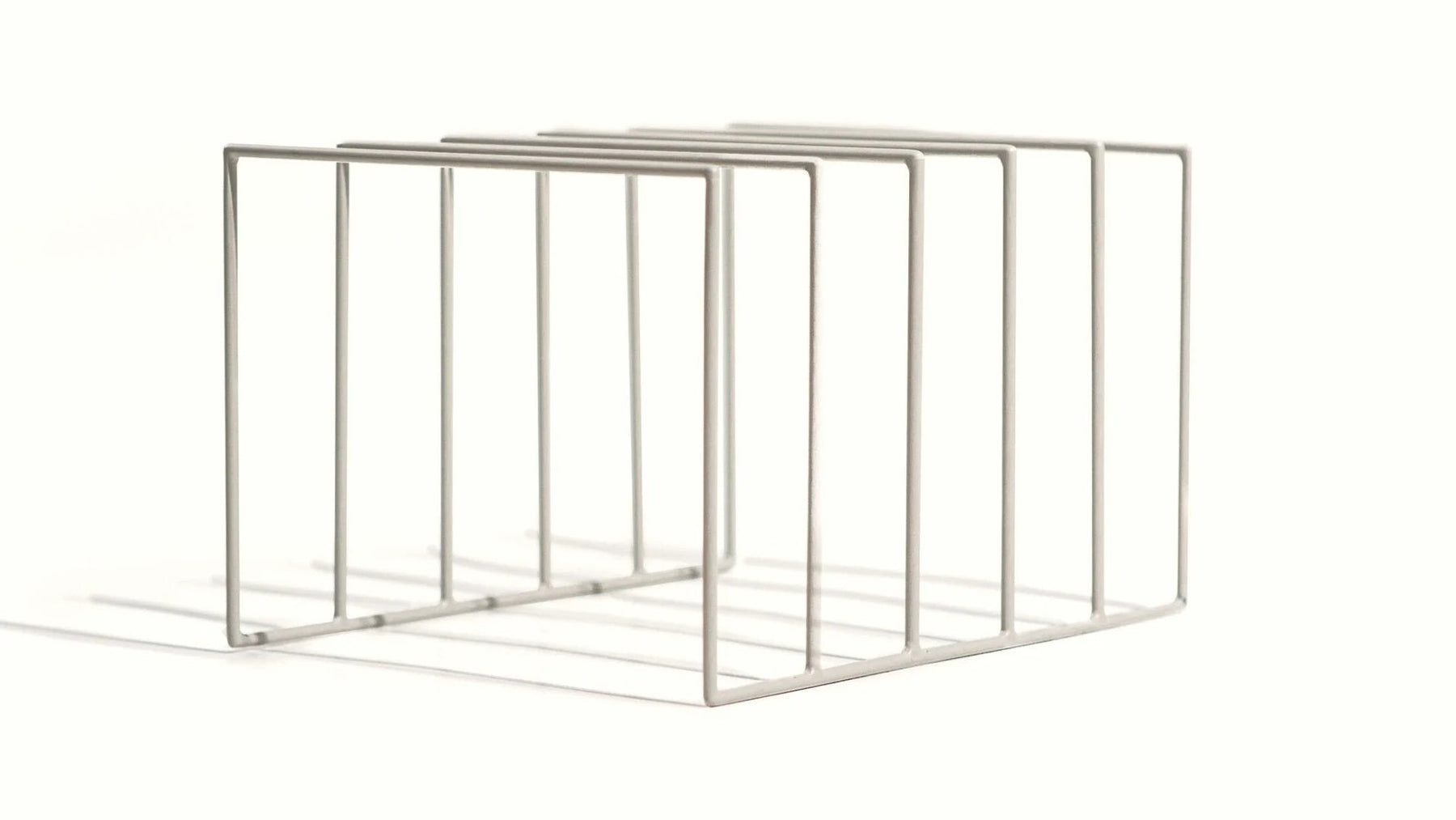 Powder-coated steel record rack with a matte white finish.