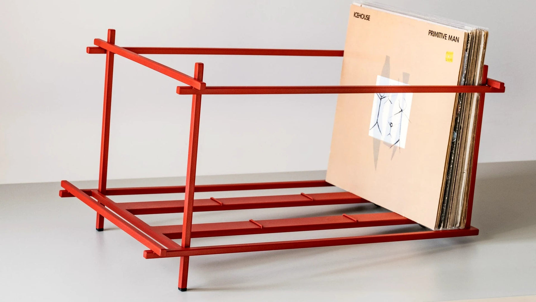 Red Sticks steel record rack seen at an angle with records loaded.