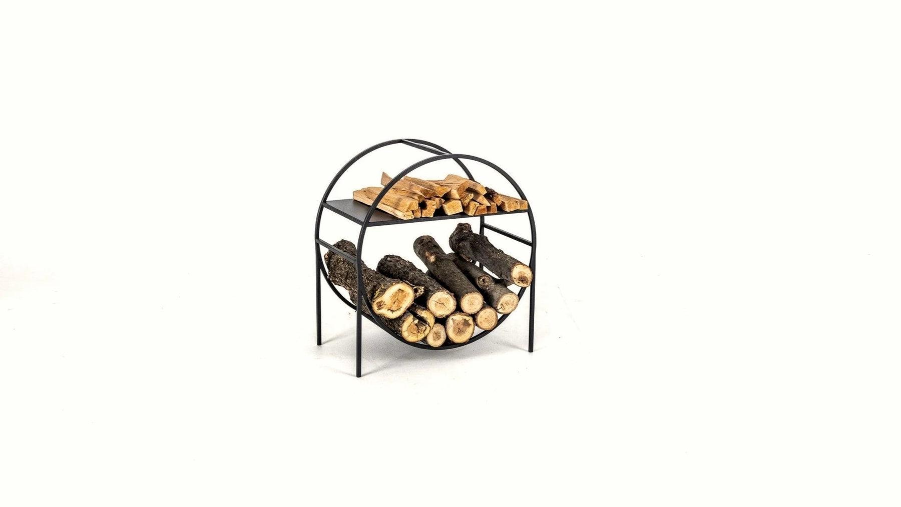 Round black steel log holder with neatly stacked firewood.
