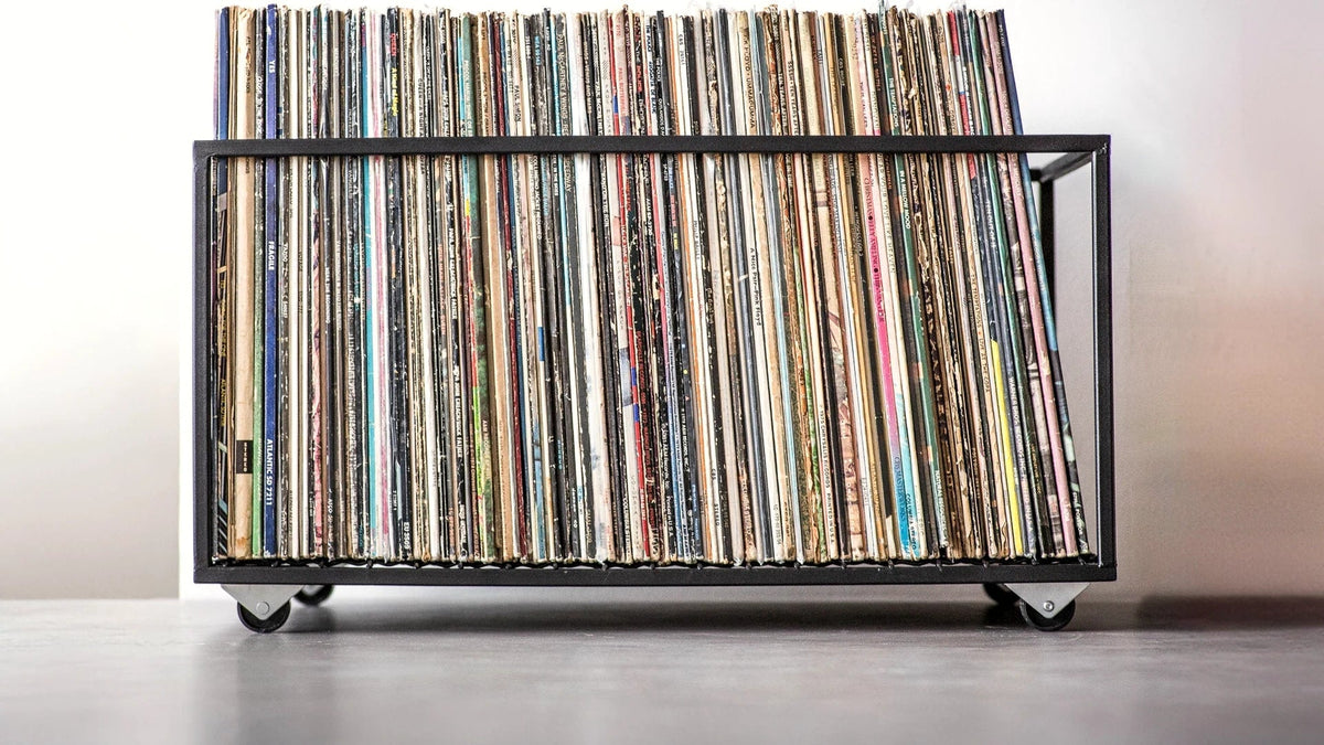 Minimalist steel crate on wheels packed with a full row of LP records.