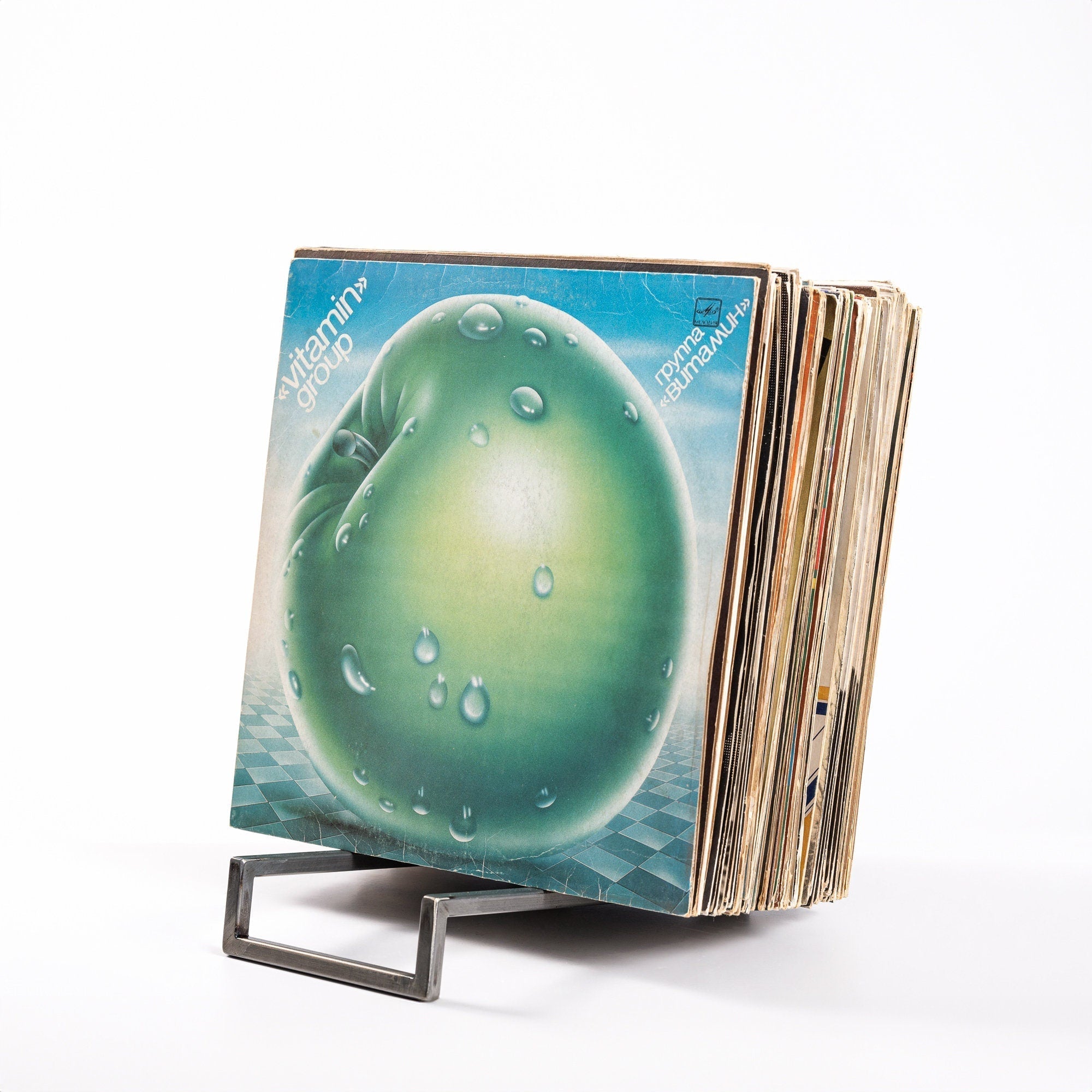 Open-frame metal vinyl record rack holding LP records