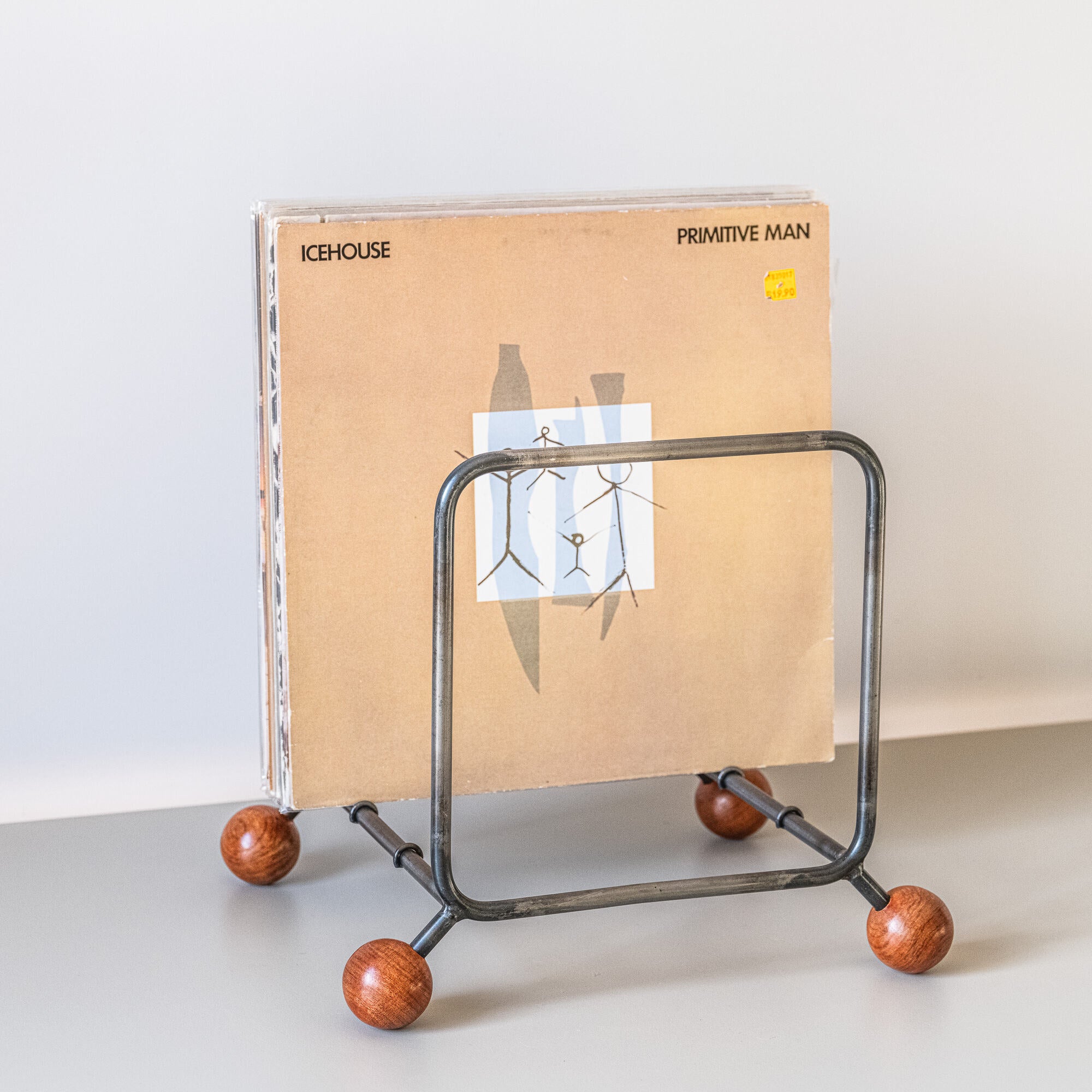 Minimalist steel vinyl record rack with wooden ball feet, for living rooms
