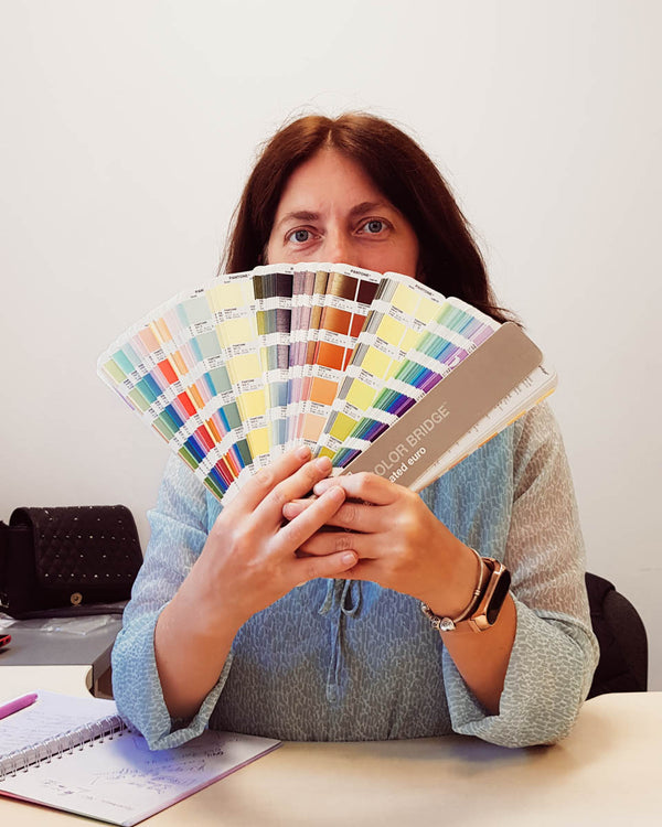 Atelier Article designer comparing finish colours with a Pantone guide