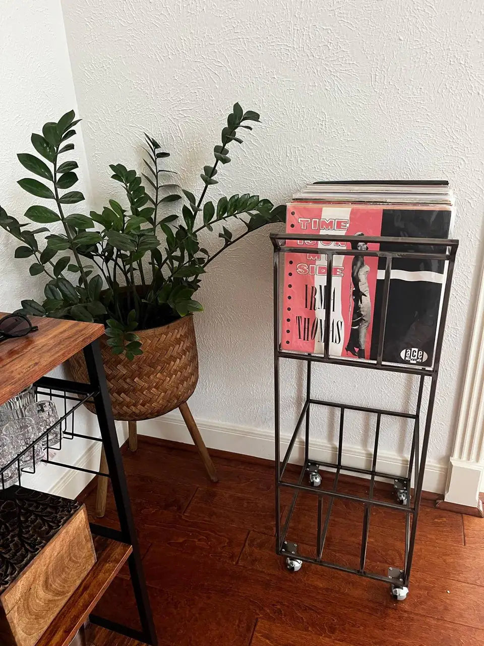 Ana’s Double-Deck Atelier Article vinyl record storage cart beside a plant in a home interior