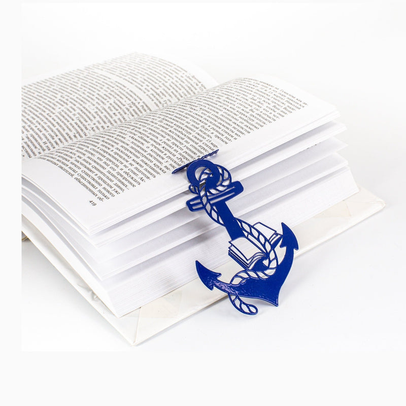 Anchor and the Books metal bookmark in blue resting on the pages of an open book