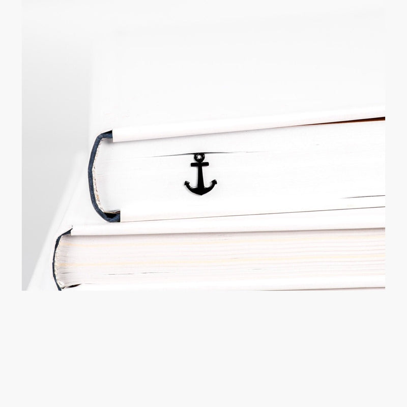 Anchor metal bookmark in a closed book, only its top showing above the pages
