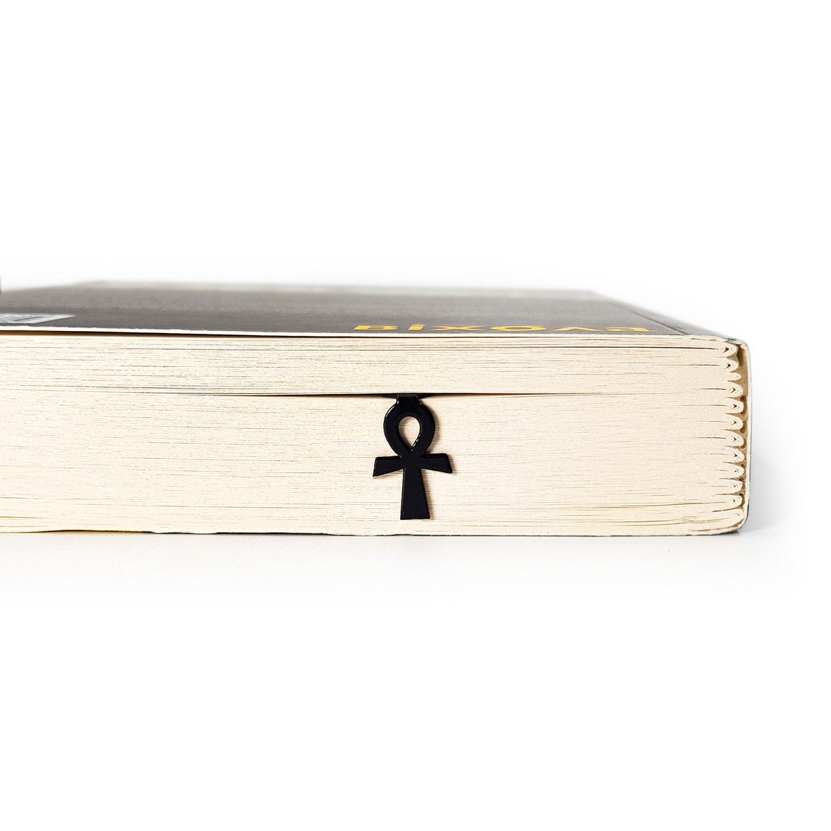 Ankh metal bookmark in a closed book, only its top showing above the pages