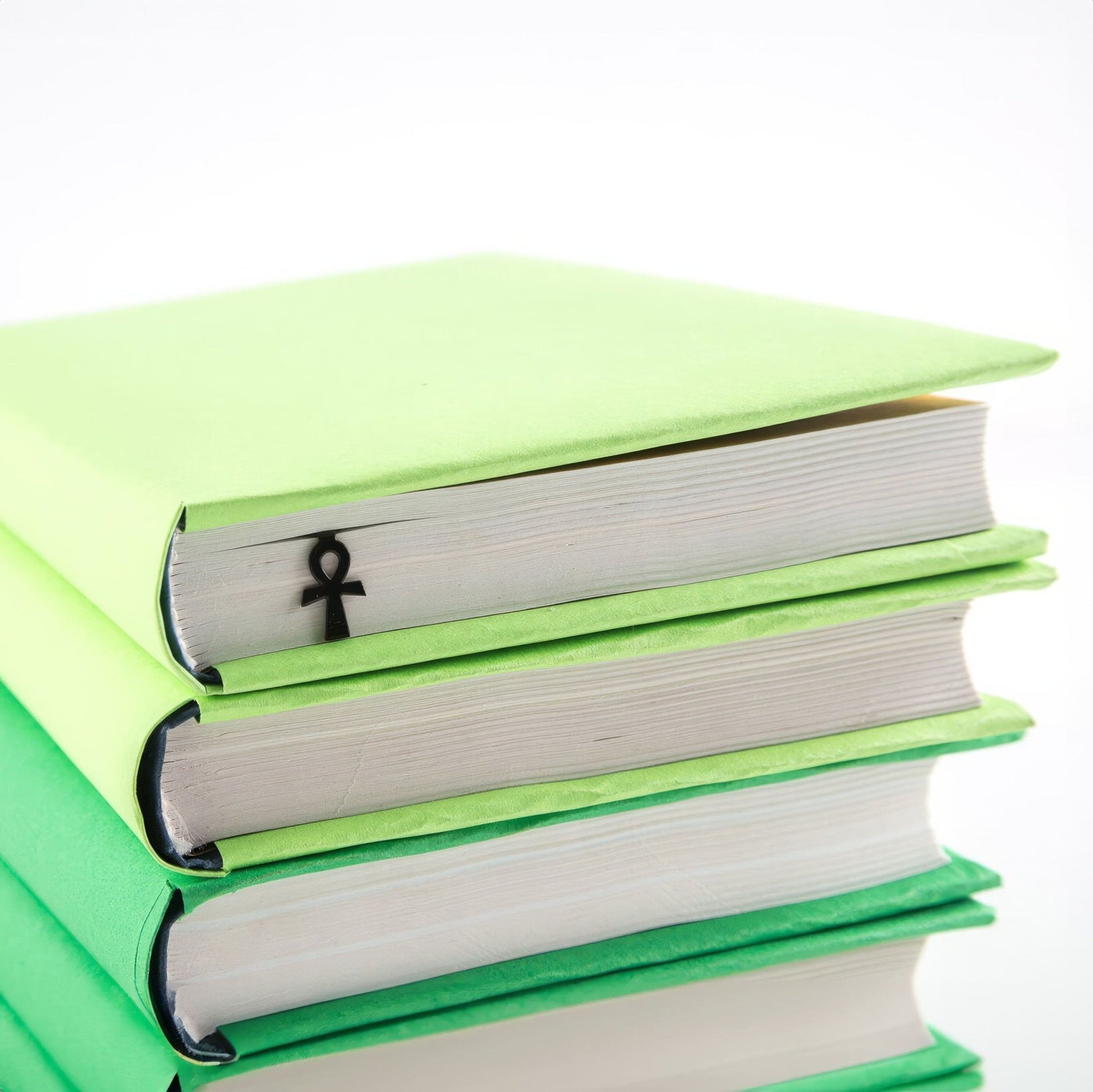 Ankh metal bookmark shown with a stack of books