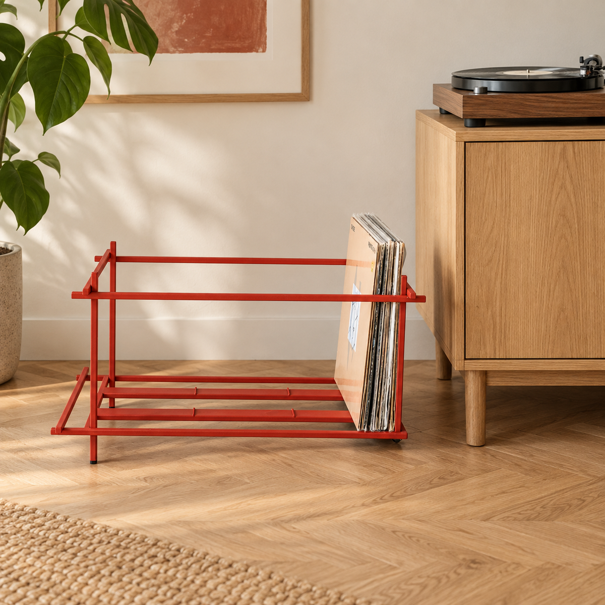Atelier Article Red Sticks red steel vinyl record crate holding LPs beside an oak cabinet and turntable