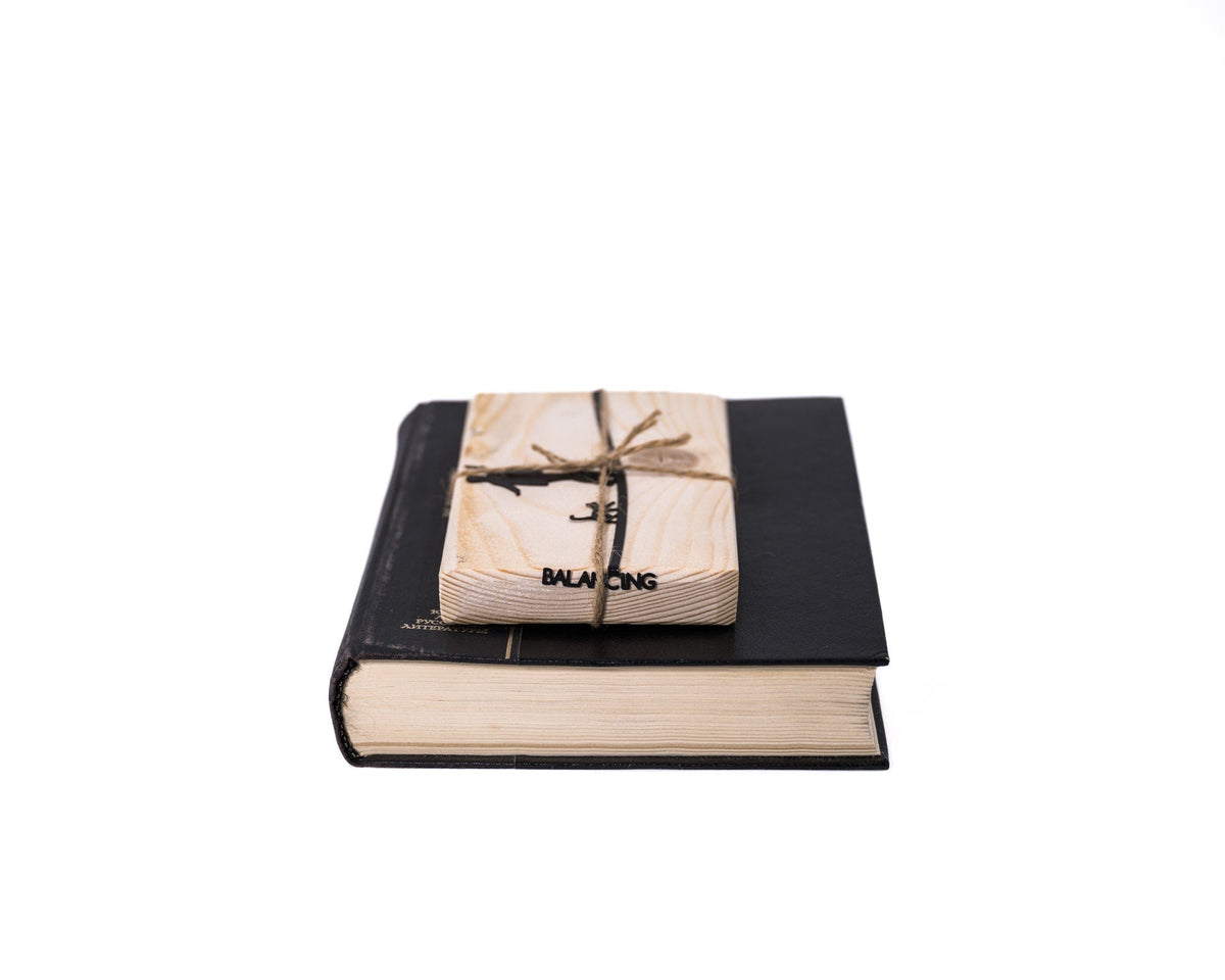 Balancing Act metal bookmark ready to give, wrapped with its wooden block